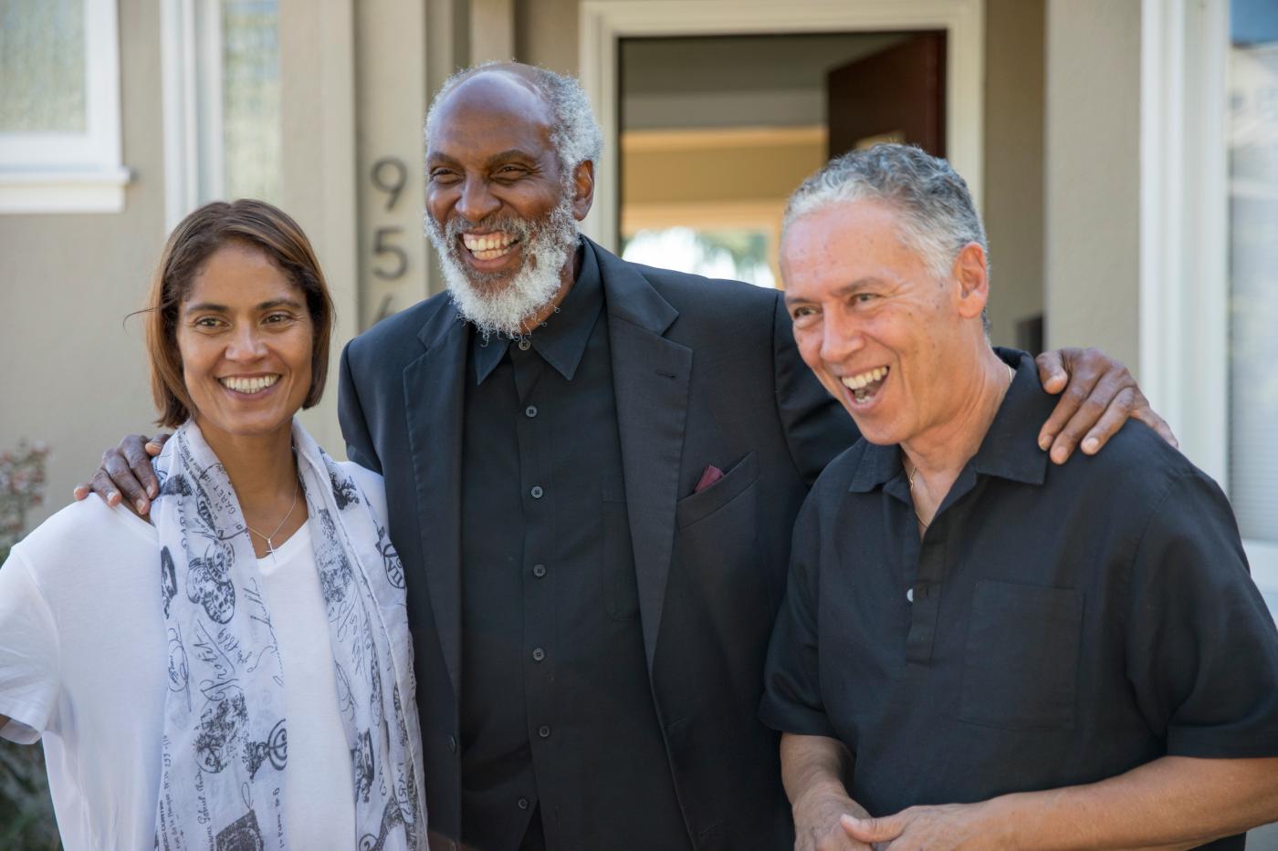 diverse group of professionals collaborating in bright modern office space with natural light, warm and inclusive atmosphere